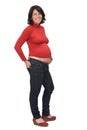 Side view of full portrait of a pregnant woman with casual clothes hands on pocket on white background Royalty Free Stock Photo
