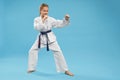 Side view of girl doing martial arts on isolated background Royalty Free Stock Photo