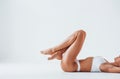 Side view of girl that lying down. Beautiful woman with slim body in underwear is in the studio Royalty Free Stock Photo