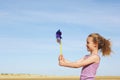 Side View Of Girl With Pinwheel On Beach