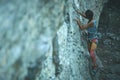 Girl rock climber climbing challenging route on the cliff Royalty Free Stock Photo