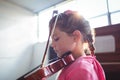 Side view of girl student rehearsing violin