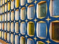 Side view of glass block wall with wooden crossbeams of blue-yellow colors, texture and background concept Royalty Free Stock Photo