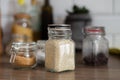 Side view of glass jar with sesame seeds, kitchen equipment, rustic style