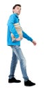 Side view of going man carries a stack of books. Royalty Free Stock Photo
