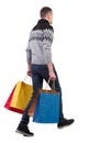 Side view of going man with shopping bags Royalty Free Stock Photo