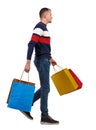 Side view of going man with shopping bags Royalty Free Stock Photo