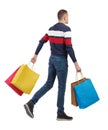 Side view of going man with shopping bags Royalty Free Stock Photo