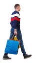 Side view of going man with shopping bags Royalty Free Stock Photo