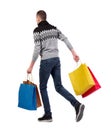 Side view of going man with shopping bags Royalty Free Stock Photo