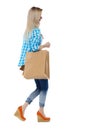 Side view of going woman with shopping bags . beautiful girl i Royalty Free Stock Photo