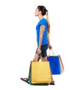 Side view of going woman with shopping bags . Royalty Free Stock Photo