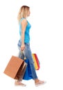 Side view of going woman with shopping bags . Royalty Free Stock Photo