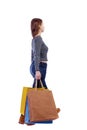 Side view of going woman with shopping bags Royalty Free Stock Photo