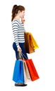 Side view of going woman with shopping bags . Royalty Free Stock Photo