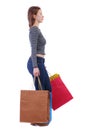 Side view of going woman with shopping bags Royalty Free Stock Photo