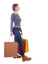 Side view of going woman in striped T-shirt with shopping bags Royalty Free Stock Photo