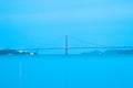 A side view of the Golden Gate Bridge at a blue dawn in San Francisco