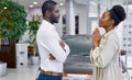 Side view on good-looking cute female begging her husband in car showroom Royalty Free Stock Photo