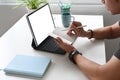 Side view of a graphic designer is taking note while working with computer tablet at his workspace. Royalty Free Stock Photo