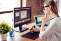 Side view of graphic designer working with interactive pen display, digital drawing tablet and pen on a computer in Royalty Free Stock Photo