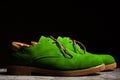 Side view of green concert shoes with laces on a black background Royalty Free Stock Photo