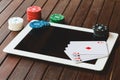 Side view of a green poker table with some poker cards on a keyboard. Betting on-line concept Royalty Free Stock Photo