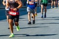 side view group male runners run together in line marathon race