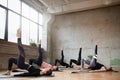 Women stretching on mats in hall.