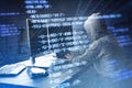 Side view of hacker using computers at desk with creative digital programming language on blurry background. Software developer, Royalty Free Stock Photo