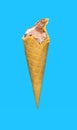 half eaten chocolate flavor ice cream cone on a blue background Royalty Free Stock Photo