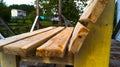 Side view of a handmade wooden bench. Garden furniture. Untreated wood. Rest in the country.