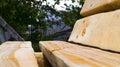 Side view of a handmade wooden bench. Garden furniture. Untreated wood. Rest in the country. Landscaping. Royalty Free Stock Photo