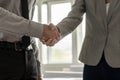 Side view of a handshake of a businessman and businesswoman