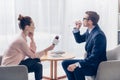 Side view of handsome businessman drinking water while giving interview to journalist with microphone Royalty Free Stock Photo