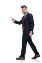 Side view of a handsome businessman stepping and pointing Royalty Free Stock Photo