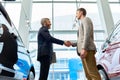 Bearded Manager Selling Cars in Showroom Royalty Free Stock Photo