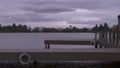 Side view of a handsome man in walking at the lake pier. Silhouette of man on the old wooden bridge natural landscape Royalty Free Stock Photo