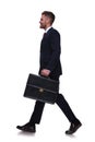 Side view of handsome young businessman walking to work Royalty Free Stock Photo