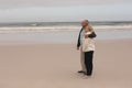 Senior couple standing with arm around at the beach Royalty Free Stock Photo