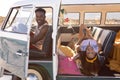 Couple looking at camera in camper van at beach Royalty Free Stock Photo