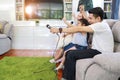 Side view happy asian family, father, mother daughter and son singing karaoke on the sofa in the living room with happy smiling Royalty Free Stock Photo