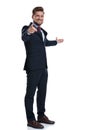 Side view of a happy businessman pointing and presenting Royalty Free Stock Photo