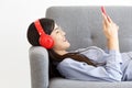 Side View of Happy cheerful Asian woman wearing wireless headphones listening to music Royalty Free Stock Photo