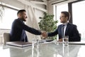 Side view happy diverse business partners shaking hands, making deal Royalty Free Stock Photo
