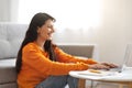 Side view of happy indian lady typing on laptop keyboard Royalty Free Stock Photo