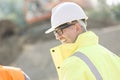 Side view of happy male supervisor at construction site Royalty Free Stock Photo