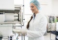 Happy employee wearing lab coat while handling sterile wipes