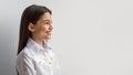 Side View Of Happy Middle Eastern Girl Against White Wall Royalty Free Stock Photo