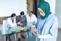 Happy female surgeon in hijab using digital tablet in the hospital Royalty Free Stock Photo